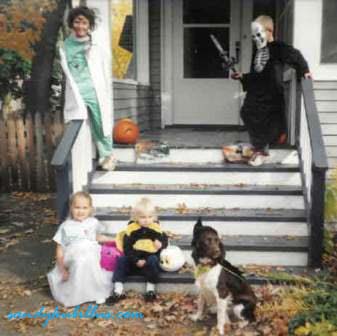 Kids and dog dressed in Halloween costumes