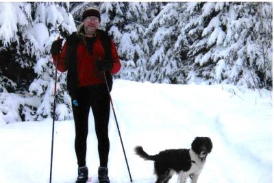 Man and dog on ski trail